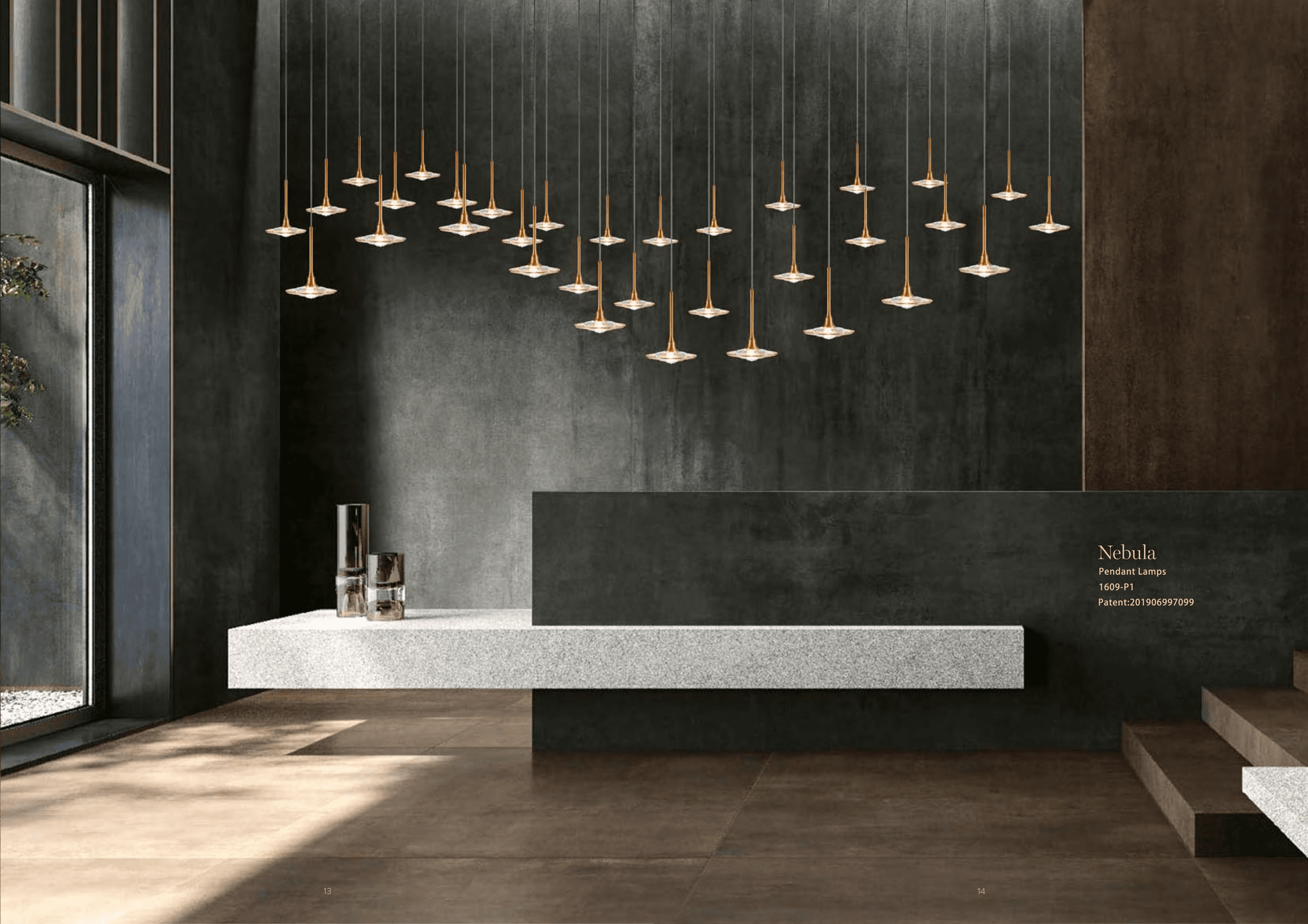 A modern interior features numerous pendant lamps with golden stems and clear, flat, circular diffusers, hanging at varying heights above a textured white counter and a dark, textured wall.