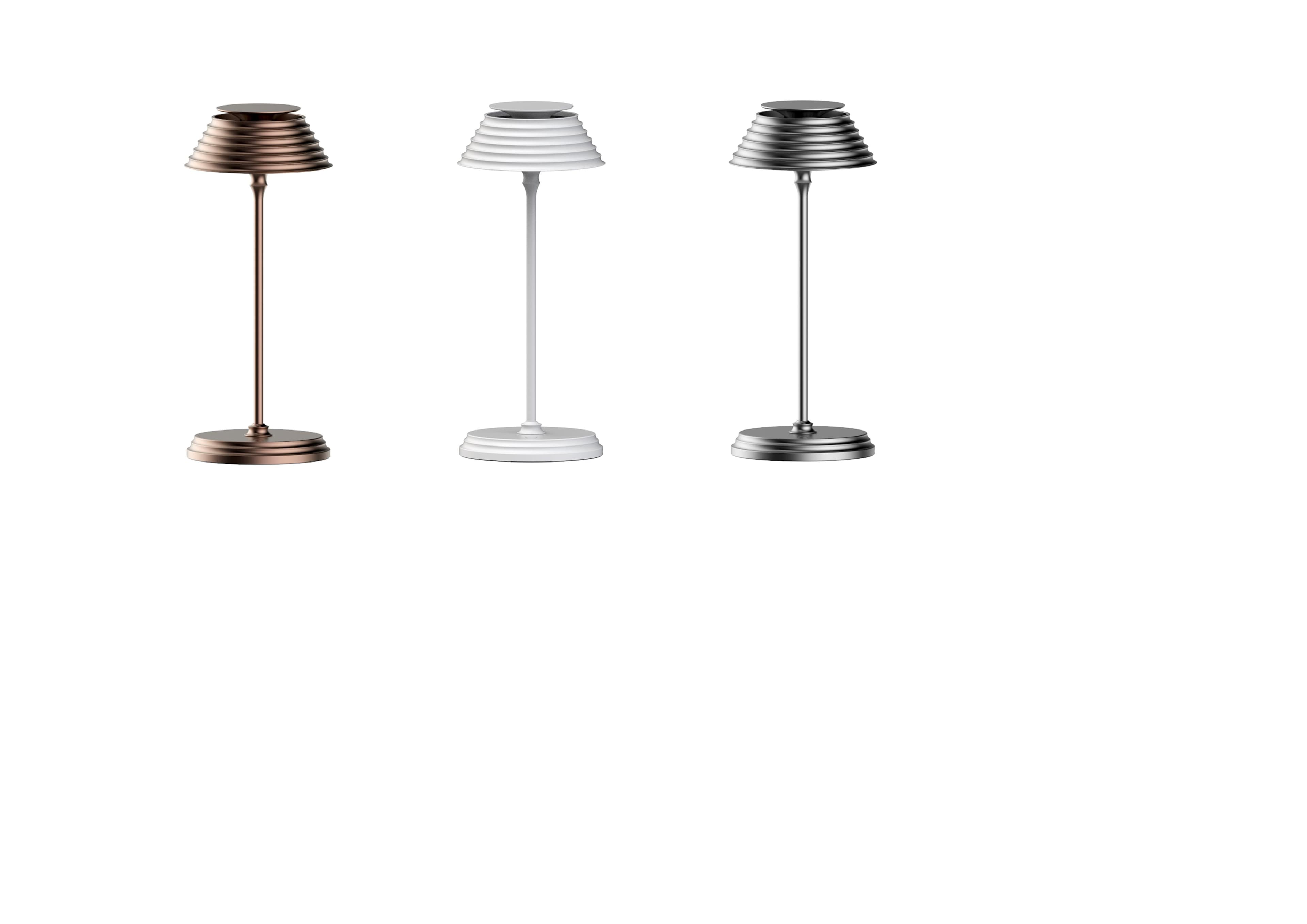 Three modern table lamps with ribbed conical shades and round bases are displayed in bronze, white, and silver finishes.
